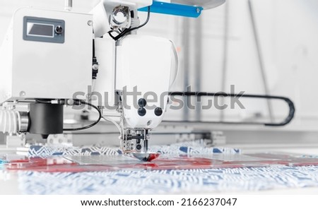 Automatic sewing machine for pocket, background white color. Concept Interior of garment factory.