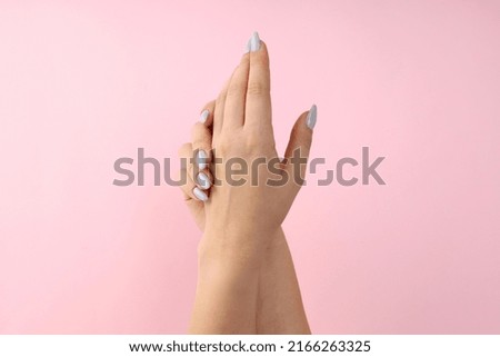 Female hands with manicure on pink background