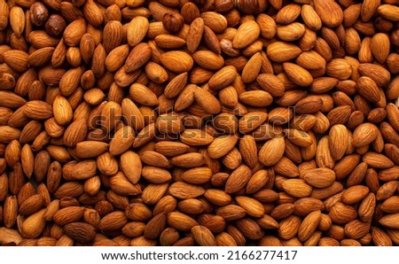 Background of big raw peeled almonds situated arbitrarily. High quality photo