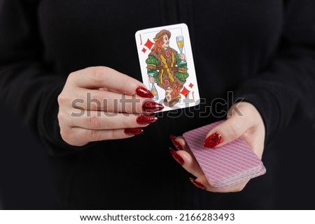 Female hands hold a deck of cards and show tricks.
The photographer is the author of the design of playing cards, which is written in the release of the property.