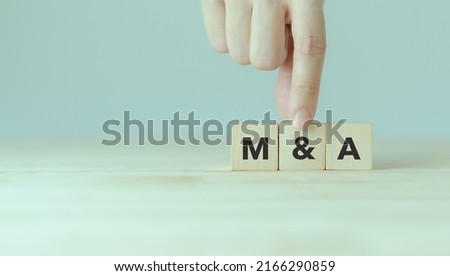 Business mergers and acquisitions concept. Share acquisition, asset business acquisition, amalgamation. Business review and development model. The abbreviation M and A on smart background, copy space. Royalty-Free Stock Photo #2166290859