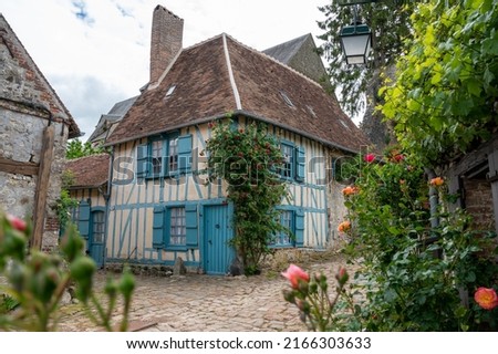 Tourist destination, one of most beautiful french villages, Gerberoy - small historical village with half-timbered houses and colorful roses flowers, France Royalty-Free Stock Photo #2166303633