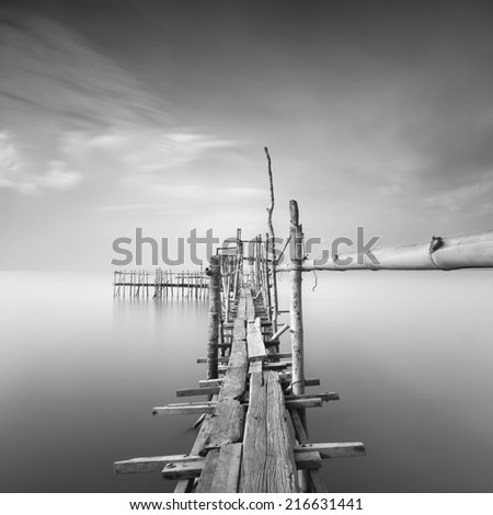 Long exposure, Black and white image of "langgai" , the traditional fishing medium at Malaysia . (Image has certain noise and soft focus )