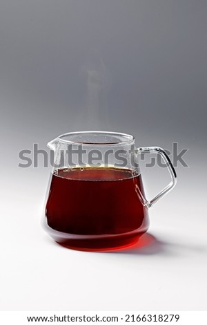 The process of making coffee in the filter. Beautiful coffee pot and glass cup. White background. Royalty-Free Stock Photo #2166318279