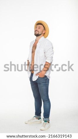 funny guy in a white shirt and a straw hat poses cheerfully with different emotions and gestures on a white background isolated in the studio in full length