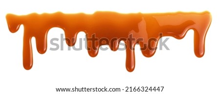 Dripping caramel drops of sweet sauce isolated on white background. Melted caramel sauce Royalty-Free Stock Photo #2166324447