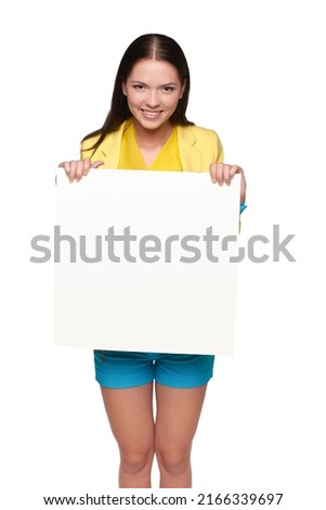 Happy smiling girl in yellow and blue, holding empty whiteboard