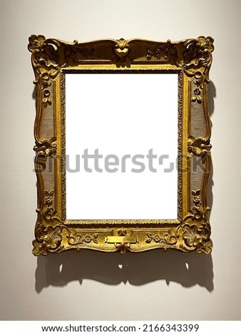 Antique golden art fair gallery frame on the wall at auction house or museum exhibition, blank template with empty white copyspace for mockup design, artwork concept Royalty-Free Stock Photo #2166343399