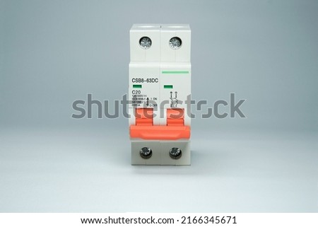 MCB or Miniature Circuit Breaker is a tool for the safety of electrical installations. 20 Ampere white MCB with orange switch on white background isolated. Royalty-Free Stock Photo #2166345671