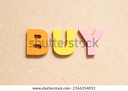 Color alphabet letter in word buy on wood background