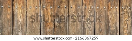 Monumental fence made of natural wooden planks, fragment. horizontal composition. The texture of the annual stripes of a tree. Image for the background. selective focus