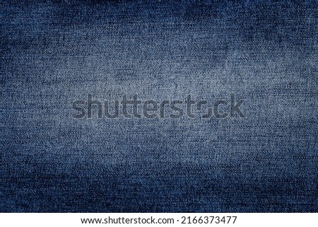 Jeans backdrop pattern with vignetting. Classic blue texture. Background of denim canvas. Design element. Copy space.