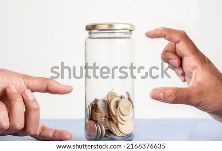 Close up photo hands pointing money collected and money missing as a symbol of point of view and crisis and opportinity. Concept of positive or negative thinking, pessimism or optimism