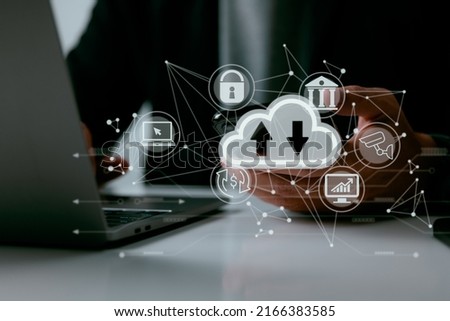 A guy uses a laptop with a cloud computing graphic. Cloud computing data storage networking and internet service ideas.
