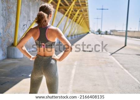 Young caucasian woman wearing sportswear at street