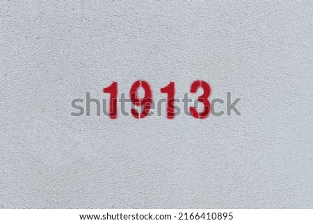 Red Number 1913 on the white wall. Spray paint.
