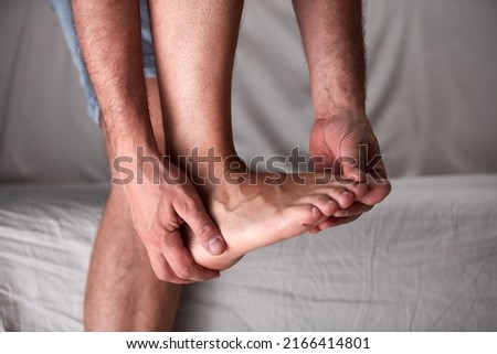 Adult male with foot pain, dislocation, numbness, cramp and other joint issues. Royalty-Free Stock Photo #2166414801