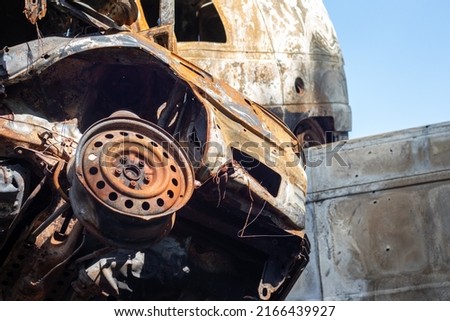 Broken and burned cars in the parking lot, accident or deliberate vandalism. Burnt car. Consequences of a car accident. Damaged by arson. Dump of civilian vehicles shot by Russian troops in Ukraine Royalty-Free Stock Photo #2166439927