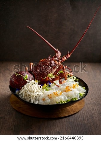 Sashimi Australian Lobster served in a dish side view on dark background Royalty-Free Stock Photo #2166440395