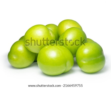 Green cherry plum on a white background. Fruit for making tkemali sauce. Useful fruit. Sweet and sour fruit. 
 Royalty-Free Stock Photo #2166459755