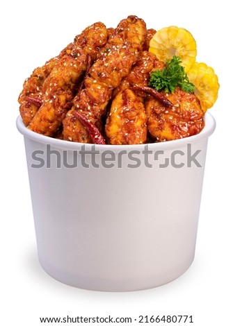Korean Fried chicken in paper bucket isolated on white background, Korean spicy sauce fried chicken on white With clipping path. Royalty-Free Stock Photo #2166480771