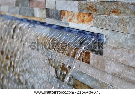 swimming pool water fountain waterfall with water Royalty-Free Stock Photo #2166484373