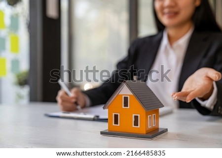 Business Signing and analyzing a contract buy - sell house, insurance agent analyzing cost about home investment loan Real Estate