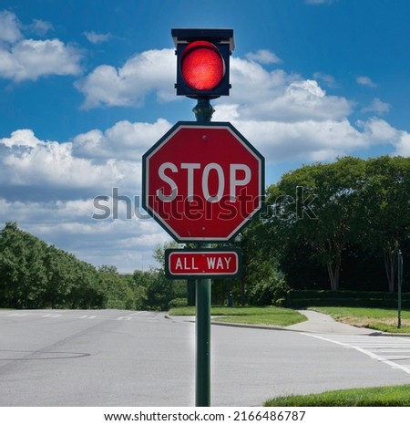 All way stop sign with traffic light.