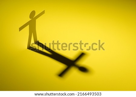white paper cutout in figure shape stand on yellow light with shadow on white background, in concept of business, enthusiastic and  individuality.