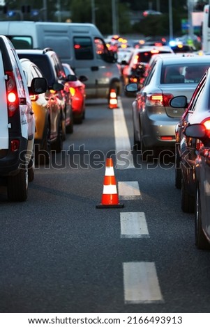 Warning cones on the road during Evening traffic jams during the traffic rush Royalty-Free Stock Photo #2166493913