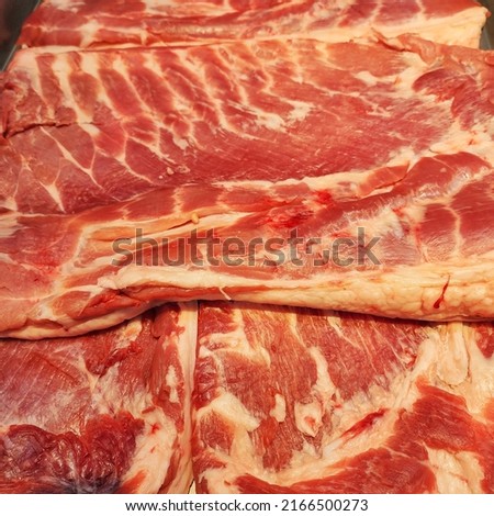 fresh pork cut into pieces  refrigerate for freshness  Colorful and appetizing to buy for cooking  Sold on shelves in  Supermarkets around the world  some blurry pictures.