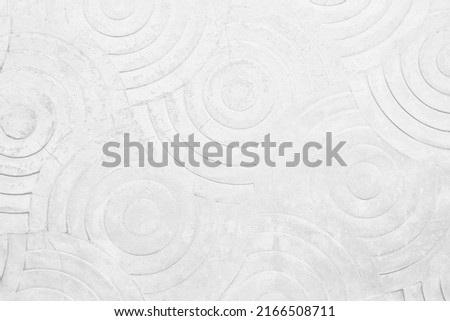 White concrete texture wall background. Abstract grey paint floor stamped concrete surface clean polished on walkway in garden. Wallpaper pattern curved circle rough gray cement stone decorative.