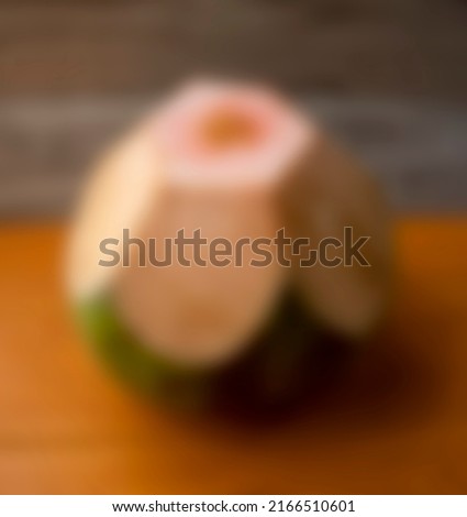 a photo of a green young coconut