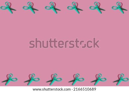 Flat lay pattern composition with school green scissors supplies on pink pastel background. Vivid color minimal overhead shot with copy space. Back to school concept. Top view with sharp shadows.