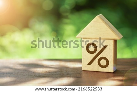 Close-up Of House Model And  wooden block with the percentage. Property investment real estate and house mortgage financial concept.                  