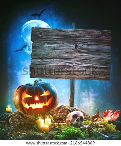 Jack O’ Lantern glowing at moonlight in the Halloween night