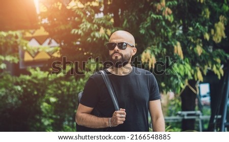 Portrait of a fashion young man at beautiful green leaves background in jungle