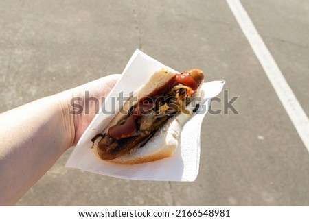 A traditional Australian barbequed sausage in bread with onions and tomato sauce  Royalty-Free Stock Photo #2166548981