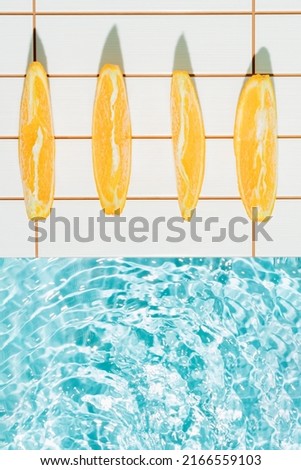 Creative arrangement made of slices of orange by the pool. Minimal summer concept. Sunbathing inspiration.