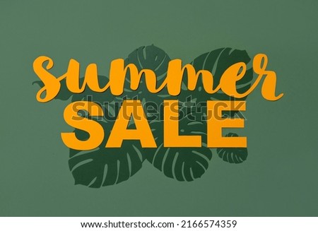 Summer Sale. Light Orange Paper Cut Letters on a Dark Green Background with Monstera Leaves. Simple Discount Composition in a Tropical Style ideal for Banner, Newsletters, Print.