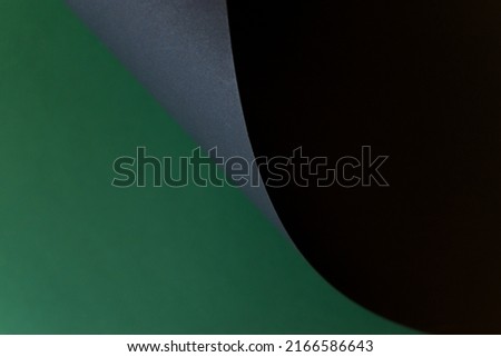 Black and green folded paper background, copy space