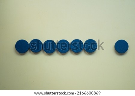 Wooden black round shape blocks in a Row on yellow background