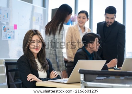 Asian businessman looking at the camera Working and meeting at the office at the company with colleagues at the back