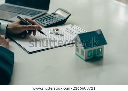 Real estate brokers, home sales agents, work on home equity loan documentation to clients and completed home title contracts. at the desk in the office Royalty-Free Stock Photo #2166603721