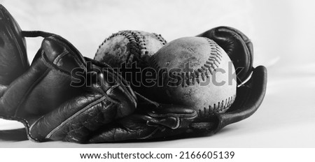 Wide angle view of baseball equipment used in game closeup in black and white, vintage style sports concept.