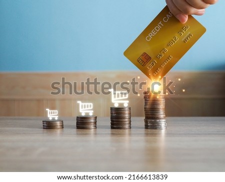 Credit card icon and pile of coins on wooden table, shopping concept, pick out likes, spending, financial comfort.