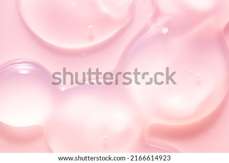 Cream gel pink orange transparent cosmetic sample texture with bubbles on peach background
