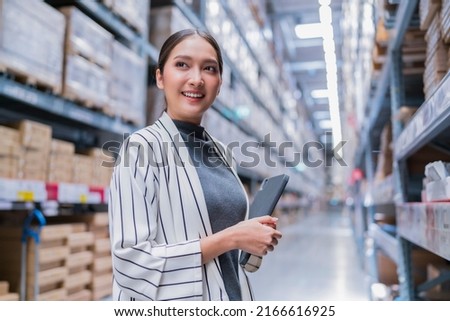 asian female business owner using digital tablet checking amount of stock product inventory on shelf at distribution warehouse factory.logistic business shipping and delivery logistic service Royalty-Free Stock Photo #2166616925