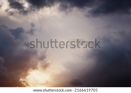 Cloudy dramatic rainy sky background with sunlight. Panoramic view with beautiful stormy clouds. Horizontal cloudscape. High-resolution photography. Design element. Copy space. 