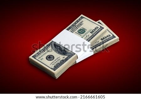 Bundle of US dollar bills on crimson red background. Pack of american money with high resolution on dark red background with dark vignette